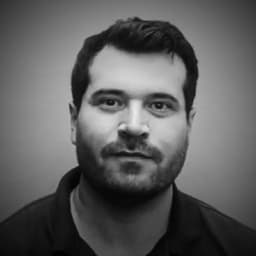 Michael D. Whitt grinning, black and white